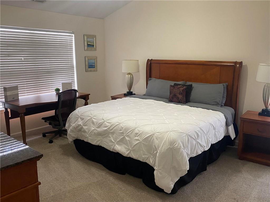 541 Cascade Hills Court Southwest Atlanta, GA 30331 - Photo 26 of 38 a bed sitting in a bedroom next to a window