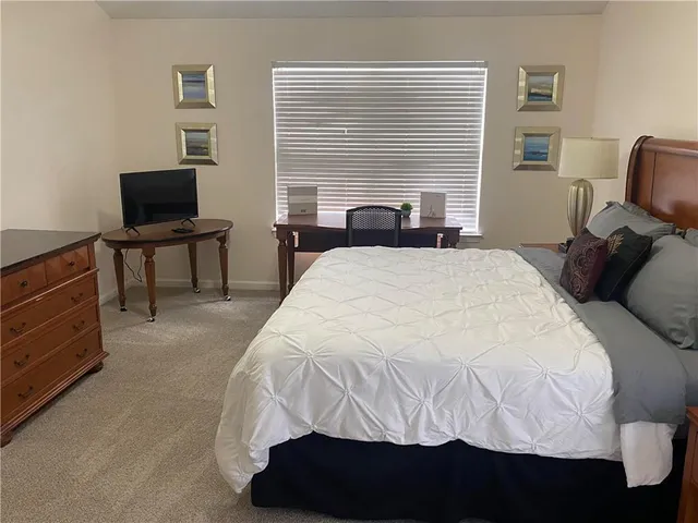 a bedroom with a bed and a television