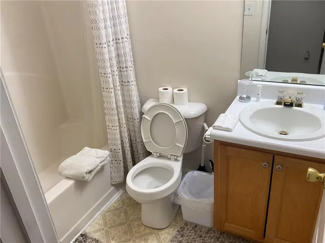a bathroom with a sink toilet and a mirror
