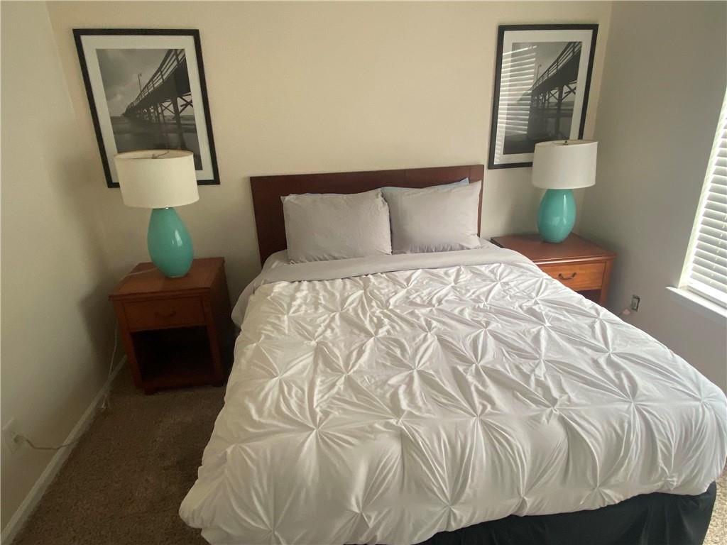 541 Cascade Hills Court Southwest Atlanta, GA 30331 - Photo 35 of 38 a bedroom with a bed and wooden floor