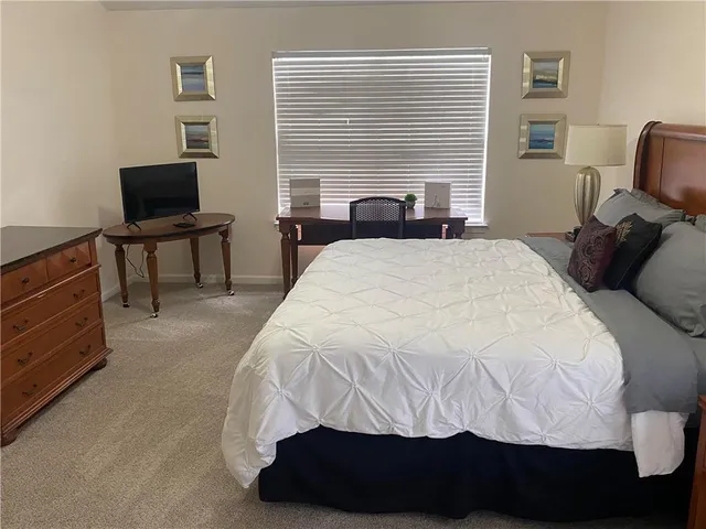 a bedroom with a bed and a chair