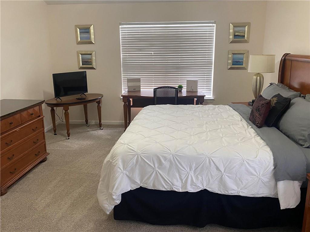 541 Cascade Hills Court Southwest Atlanta, GA 30331 - Photo 36 of 38 a bedroom with a bed and a chair