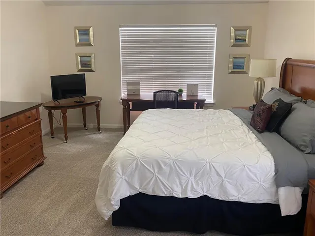 a bedroom with a bed and a television