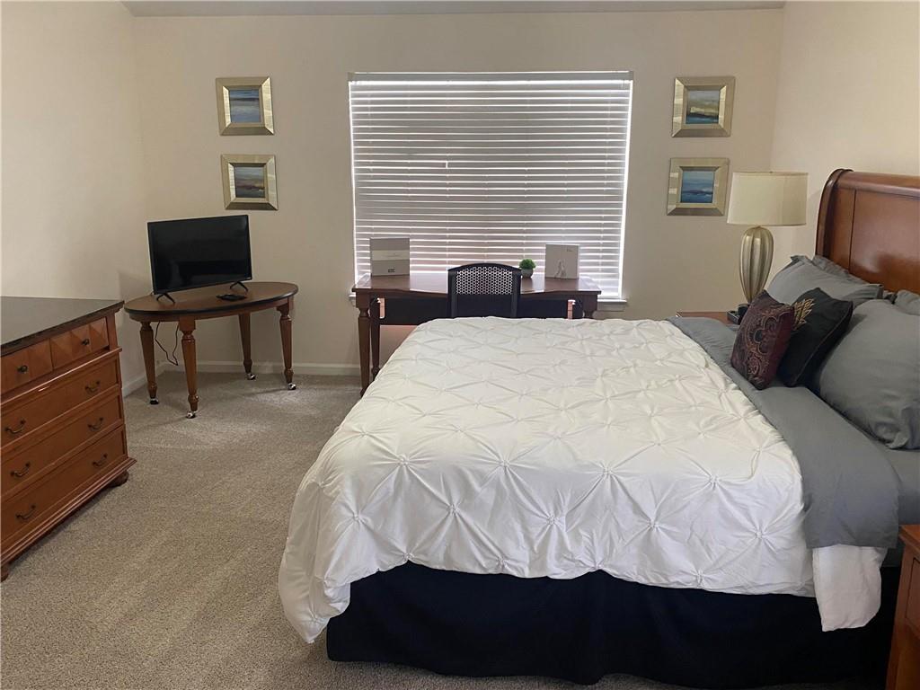 541 Cascade Hills Court Southwest Atlanta, GA 30331 - Photo 37 of 38 a bedroom with a bed and a television