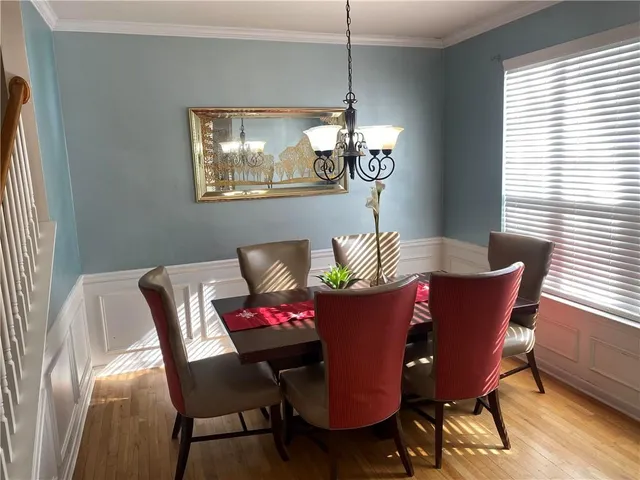 a dining room with furniture a potted plant and a chandelier