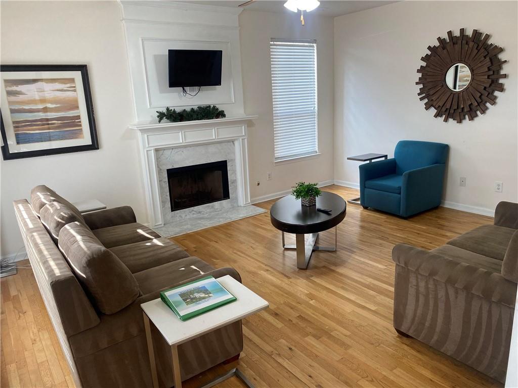 541 Cascade Hills Court Southwest Atlanta, GA 30331 - Photo 10 of 38 a living room with furniture a flat screen tv and a fireplace