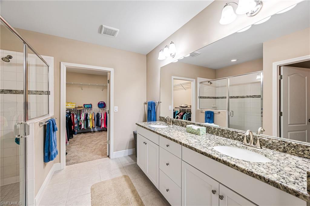6969 Avalon Circle, Unit 1504 Naples, FL 34112 - Photo 21 of 42 a bathroom with a granite countertop sink double vanity
