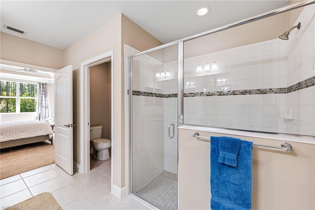 6969 Avalon Circle, Unit 1504 Naples, FL 34112 - Photo 22 of 42 a view of a bathroom with a tub and shower