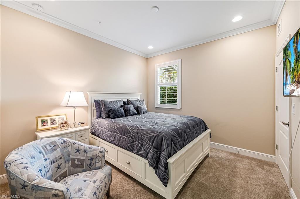 6969 Avalon Circle, Unit 1504 Naples, FL 34112 - Photo 23 of 42 a spacious bedroom with a bed and a window