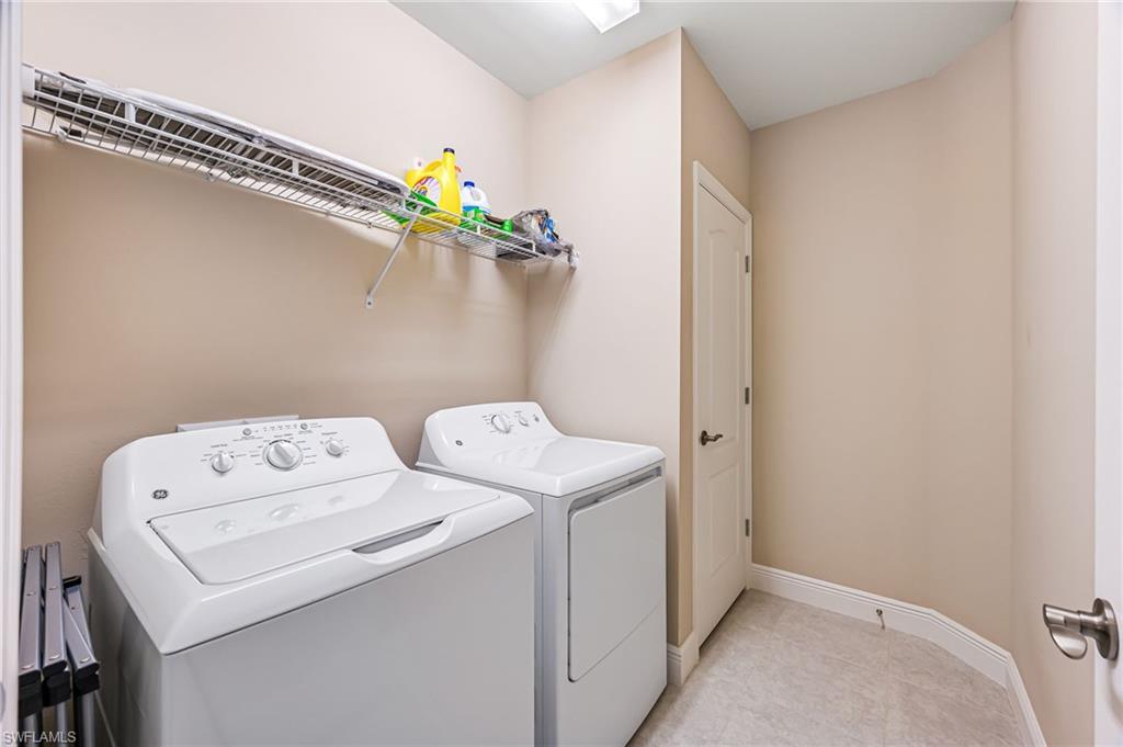 6969 Avalon Circle, Unit 1504 Naples, FL 34112 - Photo 25 of 42 a utility room with dryer and washer