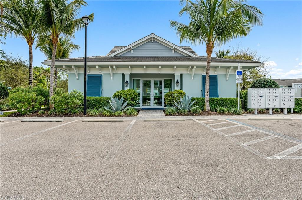 6969 Avalon Circle, Unit 1504 Naples, FL 34112 - Photo 32 of 42 a front view of a house with a garden
