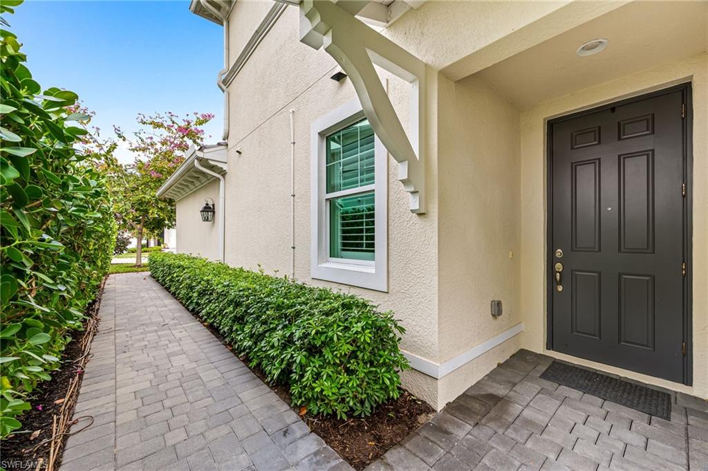6969 Avalon Circle, Unit 1504 Naples, FL 34112 - Photo 5 of 42 a view of a house with potted plants