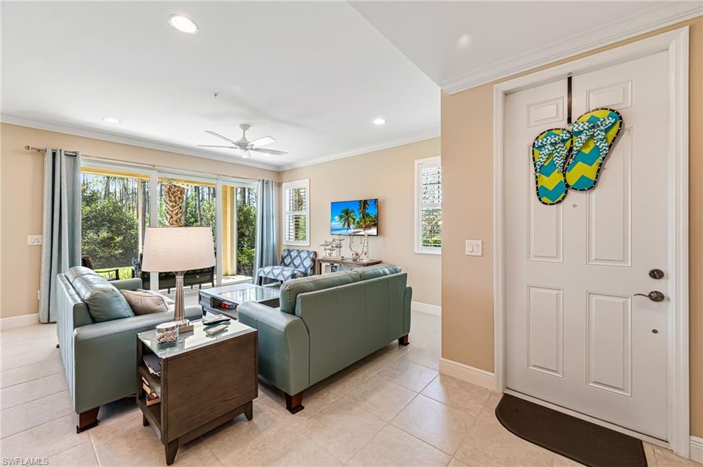 6969 Avalon Circle, Unit 1504 Naples, FL 34112 - Photo 7 of 42 a living room with furniture and a window
