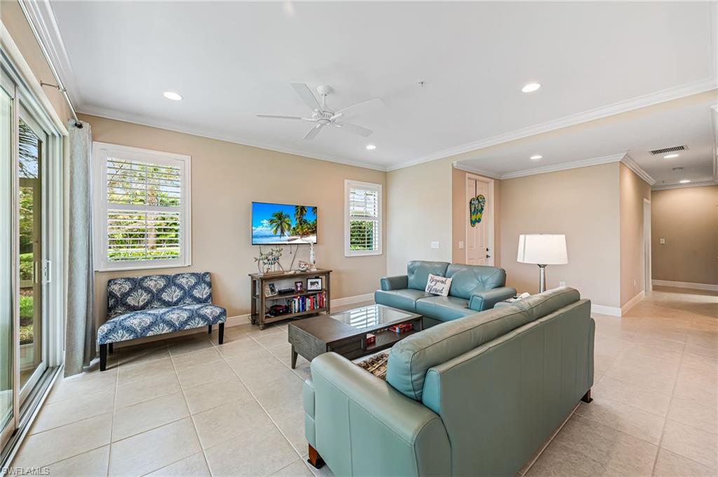 6969 Avalon Circle, Unit 1504 Naples, FL 34112 - Photo 10 of 42 a living room with furniture and a window