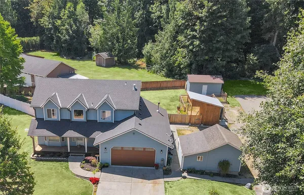 an aerial view of a house with yard
