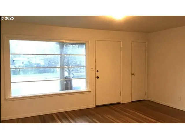 a view of an empty room with a window