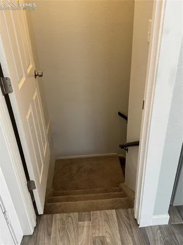 a view of walk in closet with wooden floor and tub