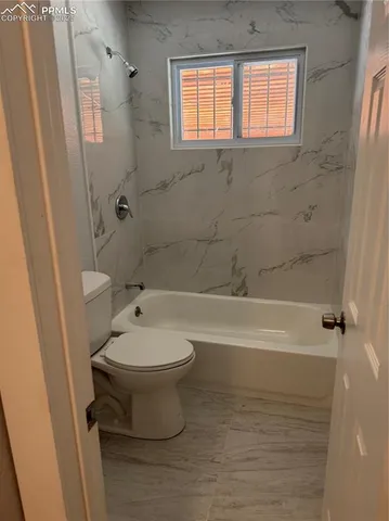 a bathroom with a toilet a sink and bathtub