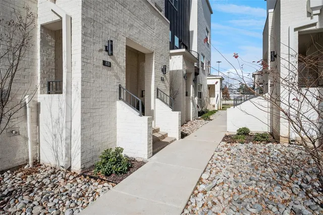 a view of a pathway along the path along with potted plants