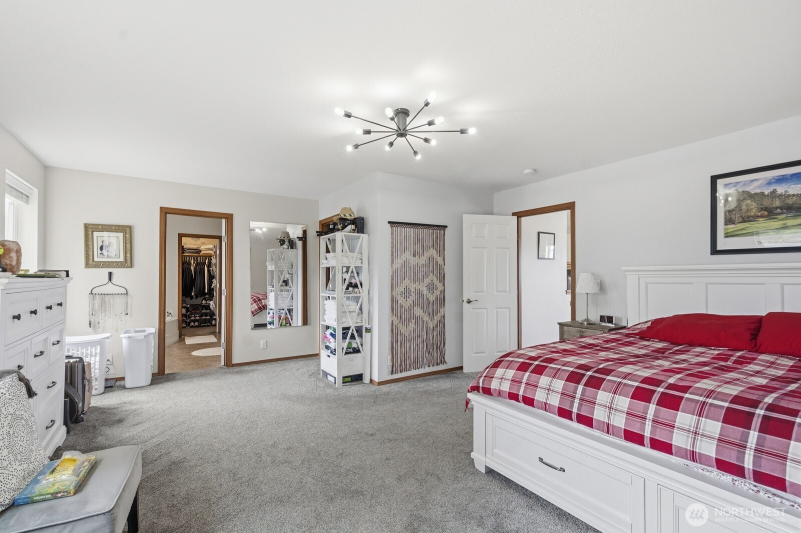 1804 Harborview Drive Aberdeen, WA 98520 - Photo 14 of 30 a bedroom with a large bed and a chandelier