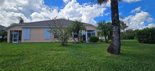 a view of a house with a backyard