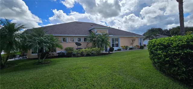 a aerial view of a house with garden and a yard