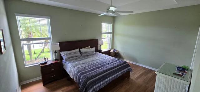 a bedroom with a bed window and a chandelier