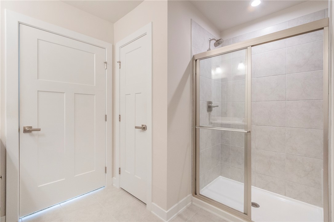 233 Scenic Road Anderson, SC 29621 - Photo 33 of 50 A well-appointed bathroom features a glass-enclosed shower with tiled walls and clean lines.