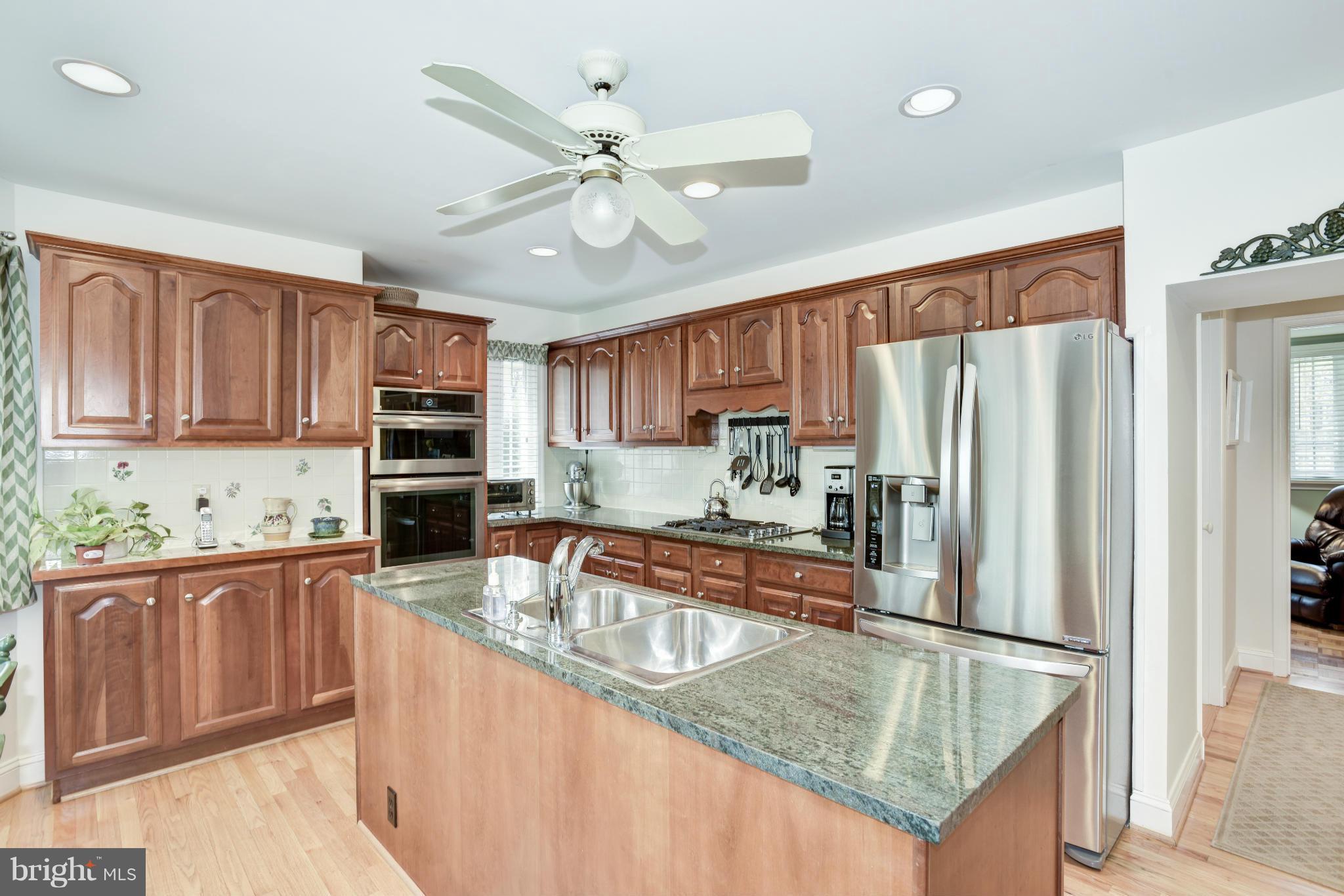 609 Chumleigh Road Baltimore, MD 21212 - Photo 12 of 30 a kitchen with stainless steel appliances granite countertop a refrigerator a stove top oven a sink and dishwasher