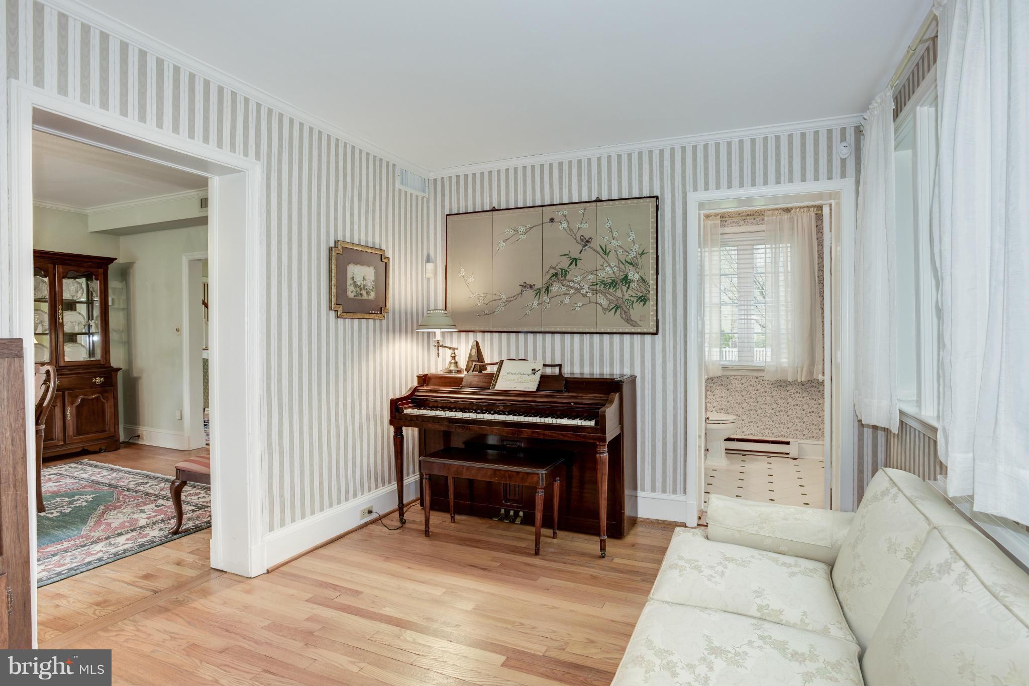609 Chumleigh Road Baltimore, MD 21212 - Photo 14 of 30 a living room with a piano and a piano