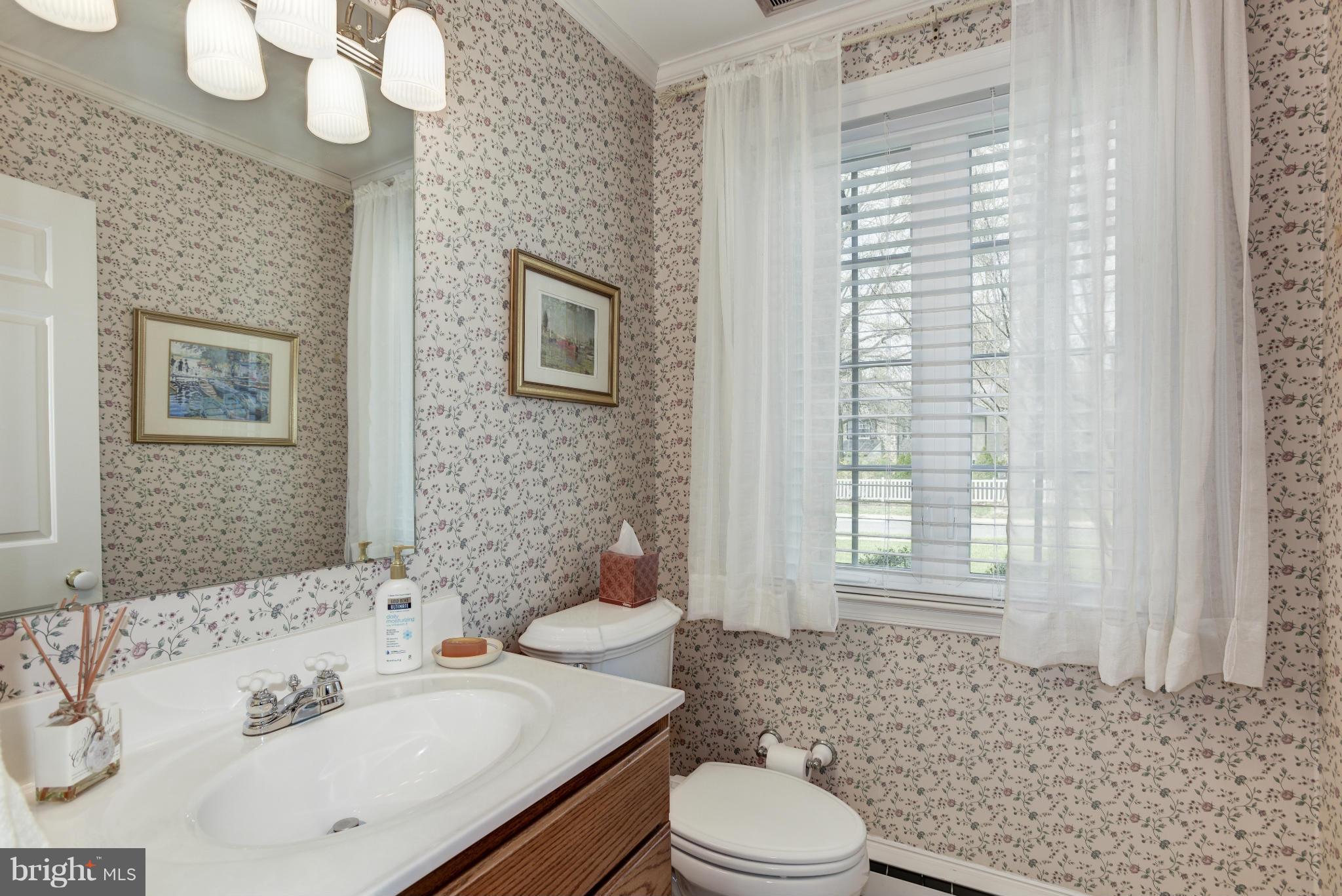 609 Chumleigh Road Baltimore, MD 21212 - Photo 15 of 30 a bathroom with a sink a toilet and shower