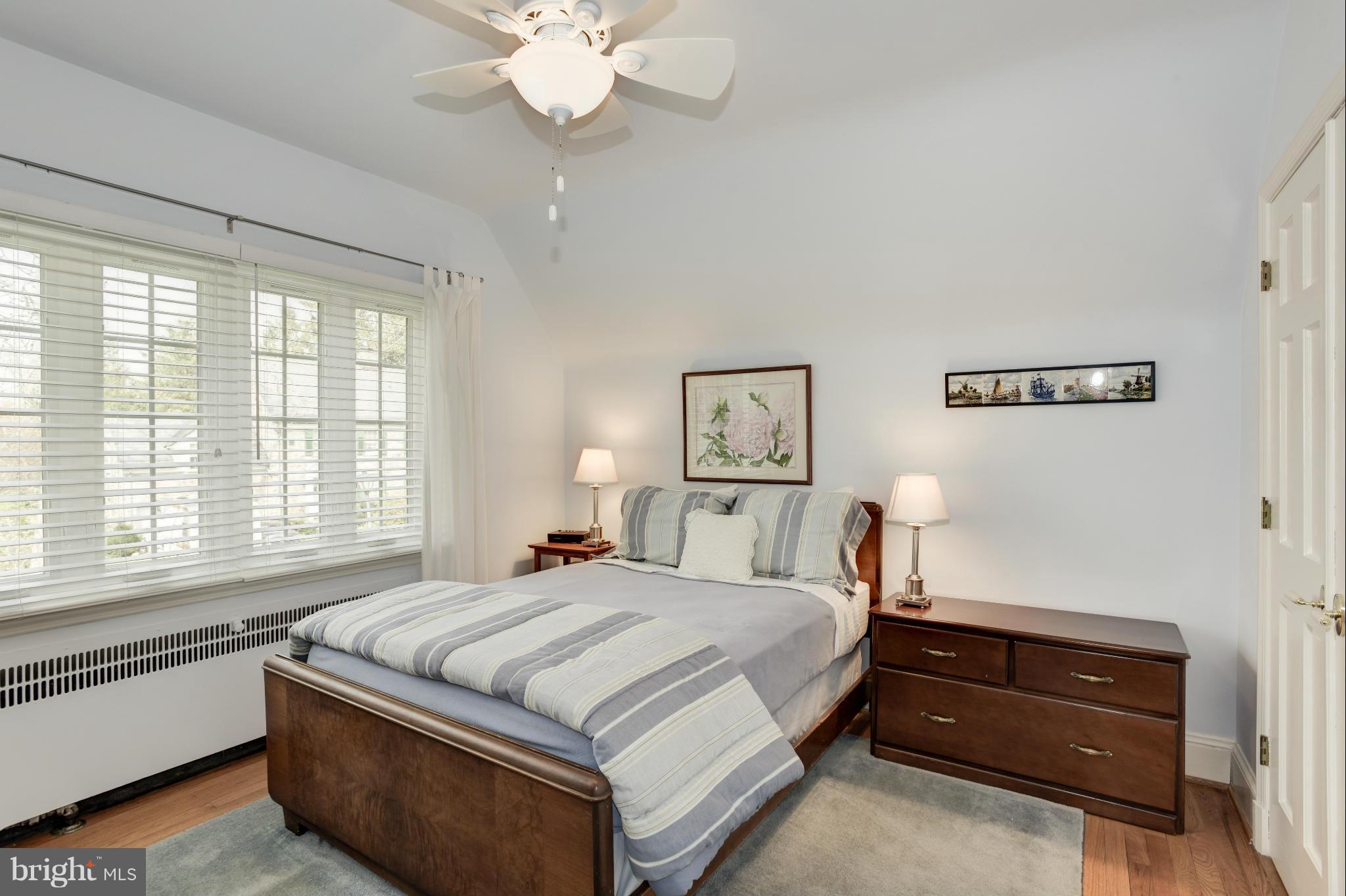 609 Chumleigh Road Baltimore, MD 21212 - Photo 23 of 30 a bedroom with a bed and a chandelier