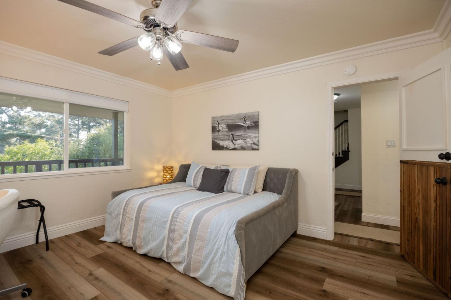 1790 Sunshine Valley Road Moss Beach, CA 94038 - Photo 12 of 30 a bedroom with a bed and a chandelier