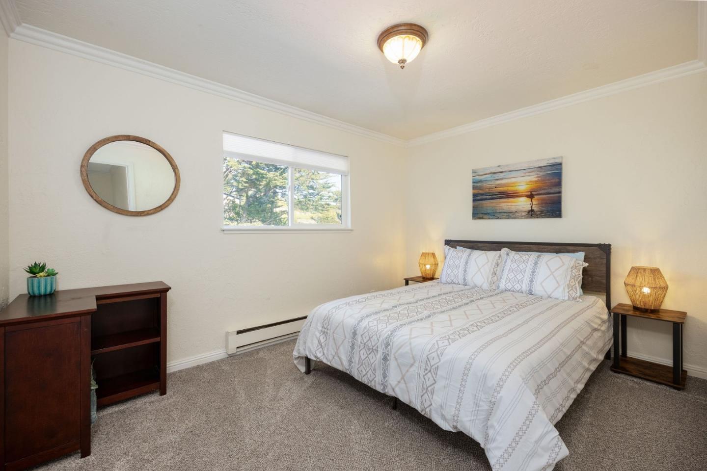 1790 Sunshine Valley Road Moss Beach, CA 94038 - Photo 17 of 30 a bedroom with a bed and a chandelier