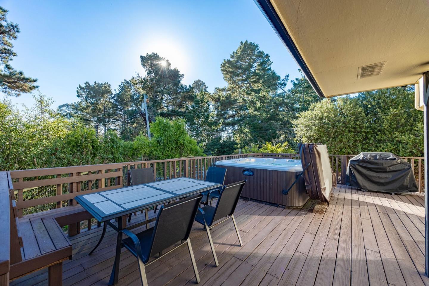 1790 Sunshine Valley Road Moss Beach, CA 94038 - Photo 22 of 30 a view of deck with table and chairs and wooden floor