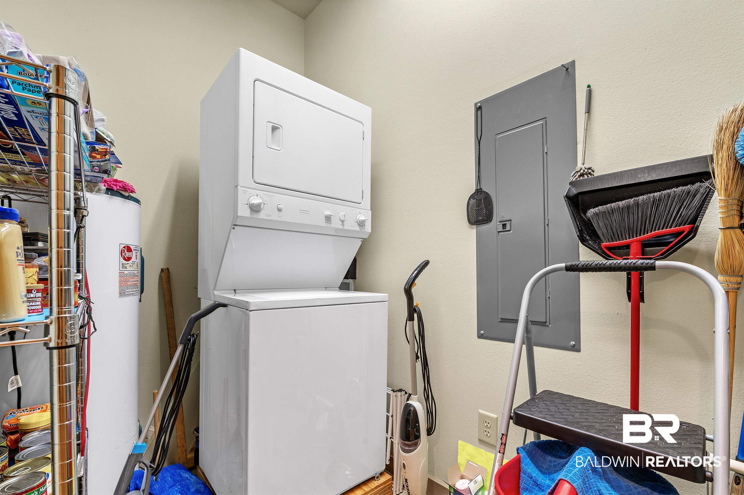 1430 Regency Road, Unit A301 Gulf Shores, AL 36542 - Photo 32 of 47 Laundry area featuring stacked washer / drying machine, electric panel, and water heater