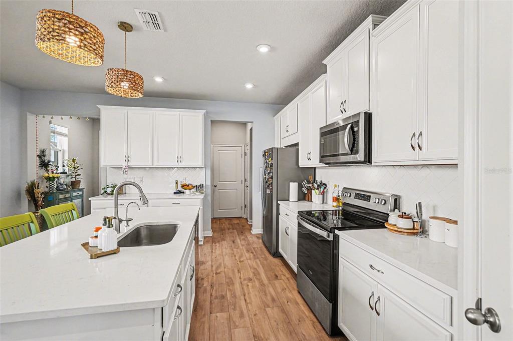 2361 Summerlit Street Lutz, FL 33558 - Photo 11 of 31 a kitchen with kitchen island granite countertop a sink a stove and cabinets