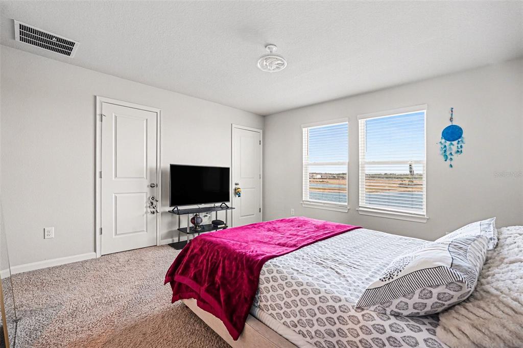 2361 Summerlit Street Lutz, FL 33558 - Photo 15 of 31 a bedroom with a bed and a flat screen tv