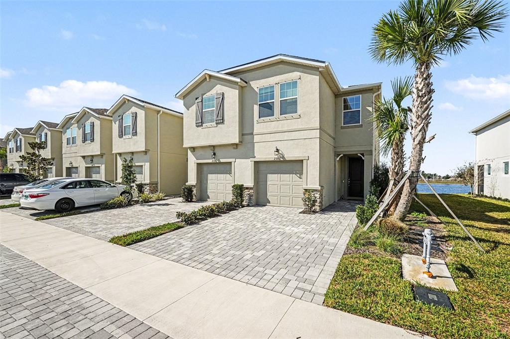 2361 Summerlit Street Lutz, FL 33558 - Photo 2 of 31 a view of a white house with a yard and plants