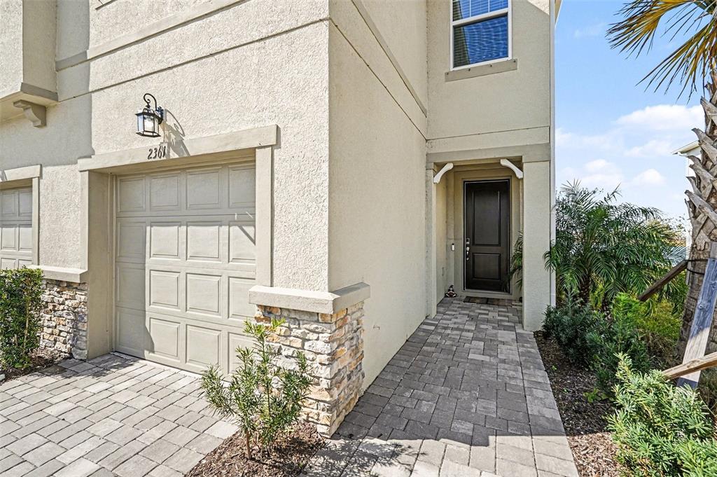 2361 Summerlit Street Lutz, FL 33558 - Photo 4 of 31 a view of a house with a door and wooden bench