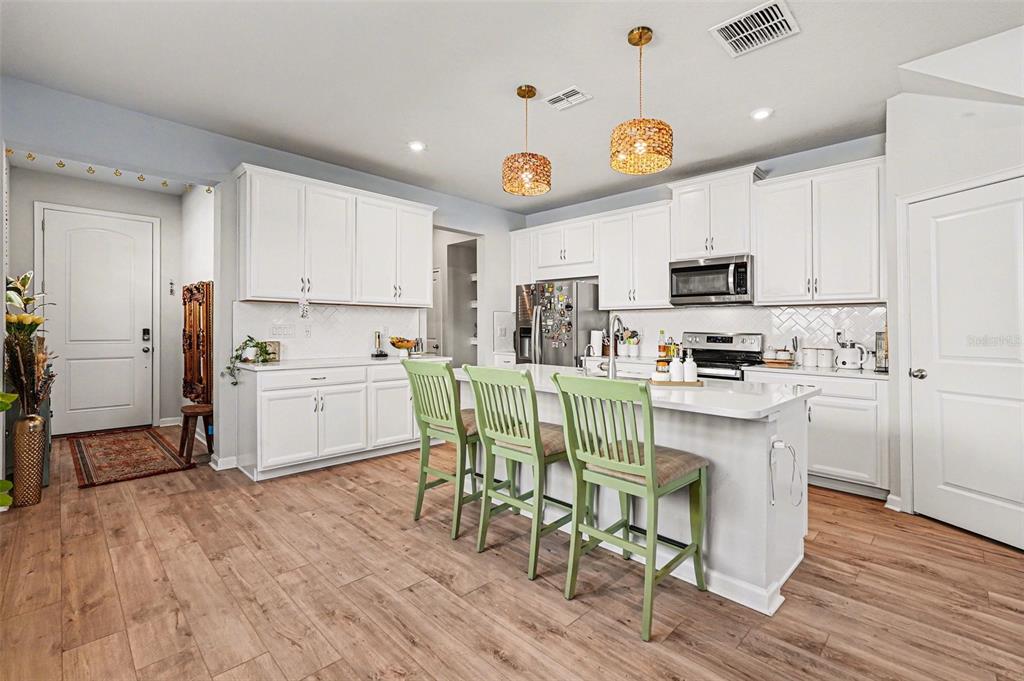 2361 Summerlit Street Lutz, FL 33558 - Photo 9 of 31 a kitchen with stainless steel appliances a white table and chairs in it