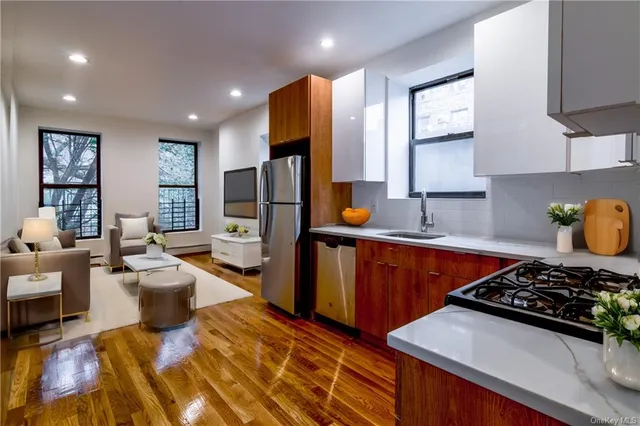 a kitchen with stainless steel appliances granite countertop a stove and a refrigerator