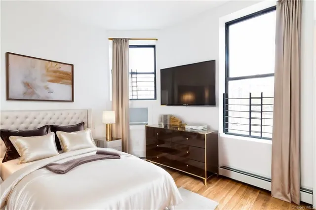 a bedroom with a bed and a flat screen tv