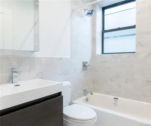 a bathroom with a sink a toilet and bathtub