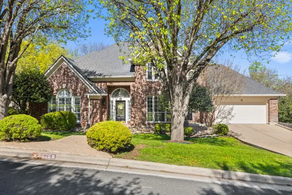 front view of a house with a tree in a yard