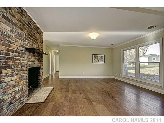 5525 Valley Forge Road Charlotte, NC 28210 - Photo 3 of 16 a view of an empty room with a fireplace and a window