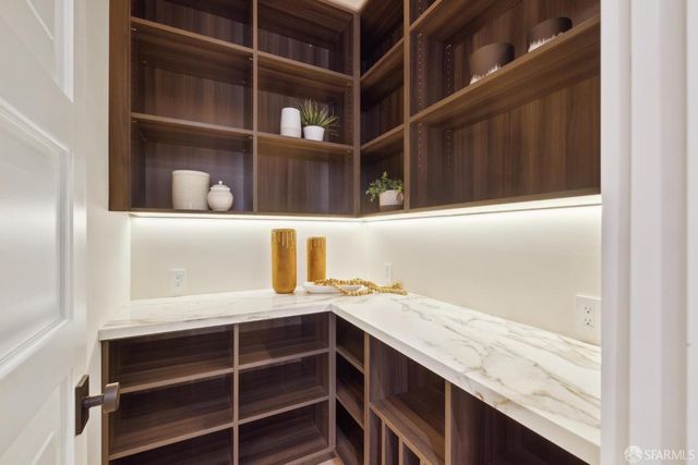 a living room with furniture and large windows