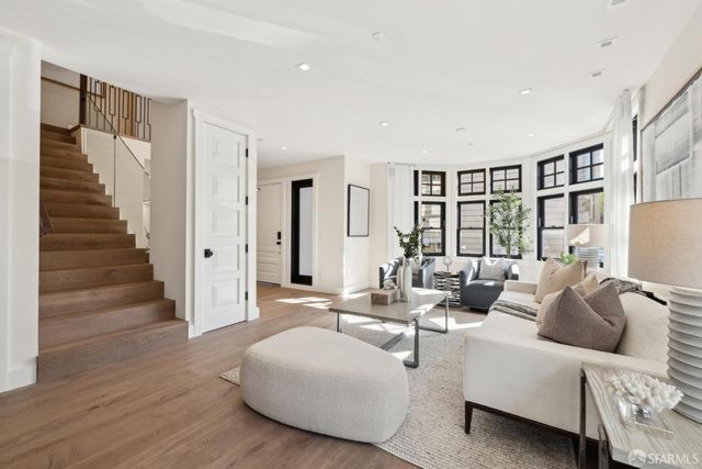 a bathroom with a bathtub sink double vanity and mirror
