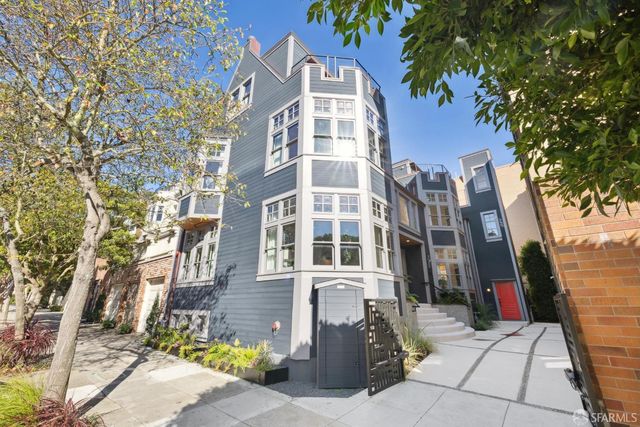 a front view of a residential apartment building with a yard