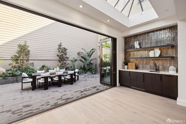 a view of a building with a table and chairs in patio
